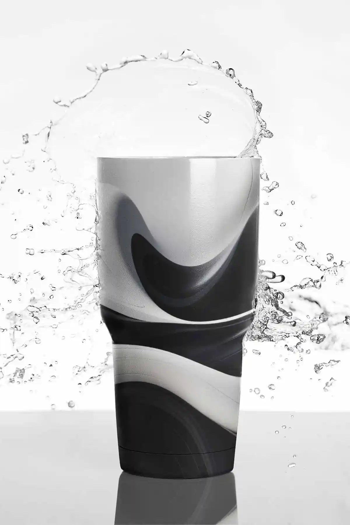 BW Ebb digital art print on a travel mug with water splashing in the background.