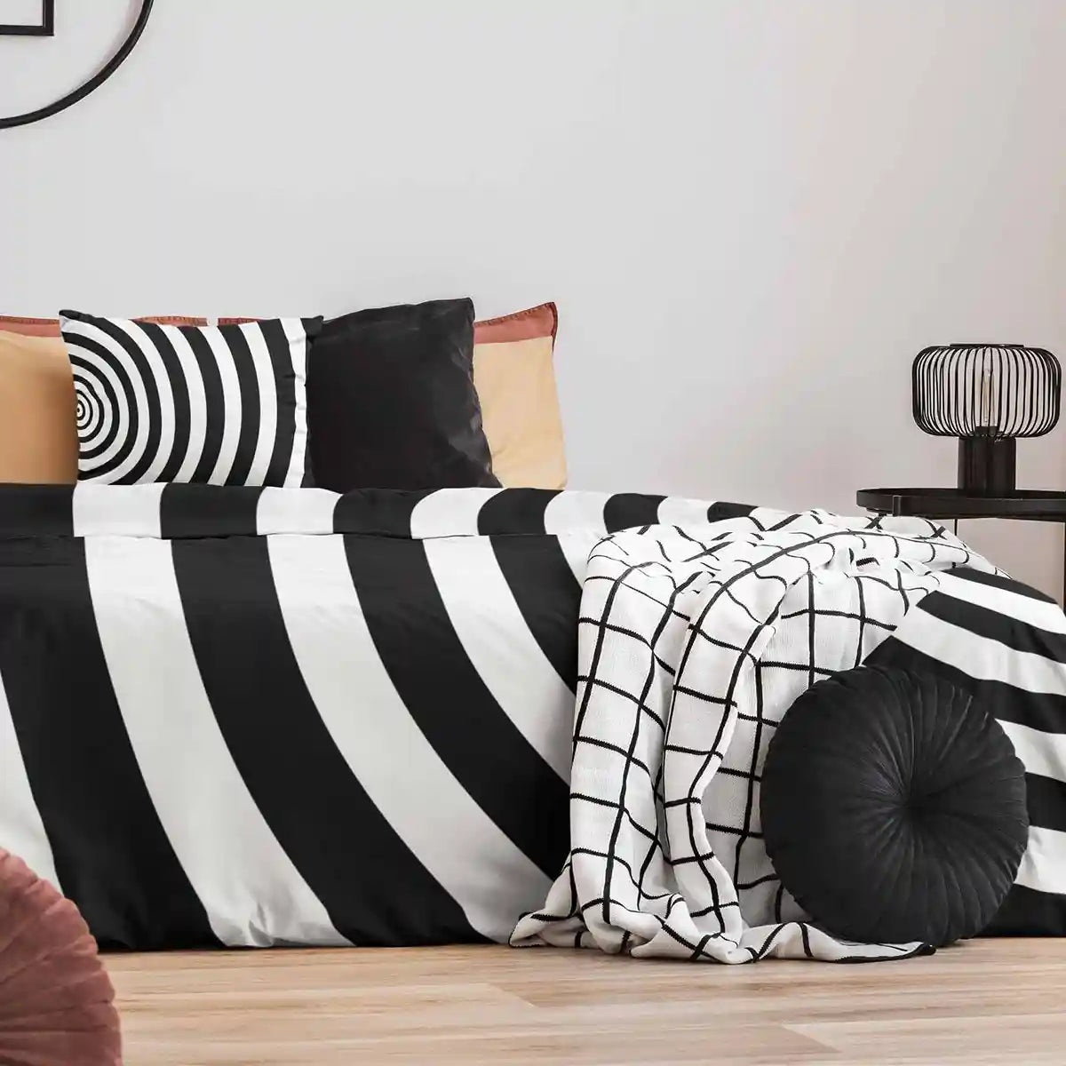 Circles art print on pillow and duvet cover in a nicely decorated bedroom.