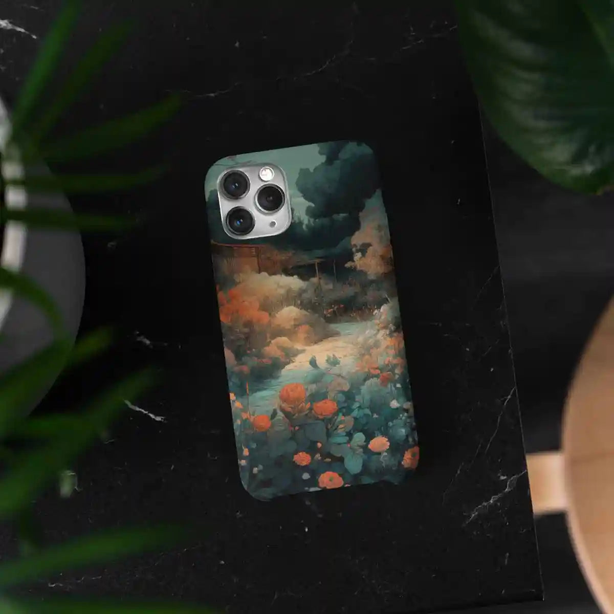 Memo digital art print on a phone case surrounded by plants, offering a unique and artistic accessory with a touch of nature.