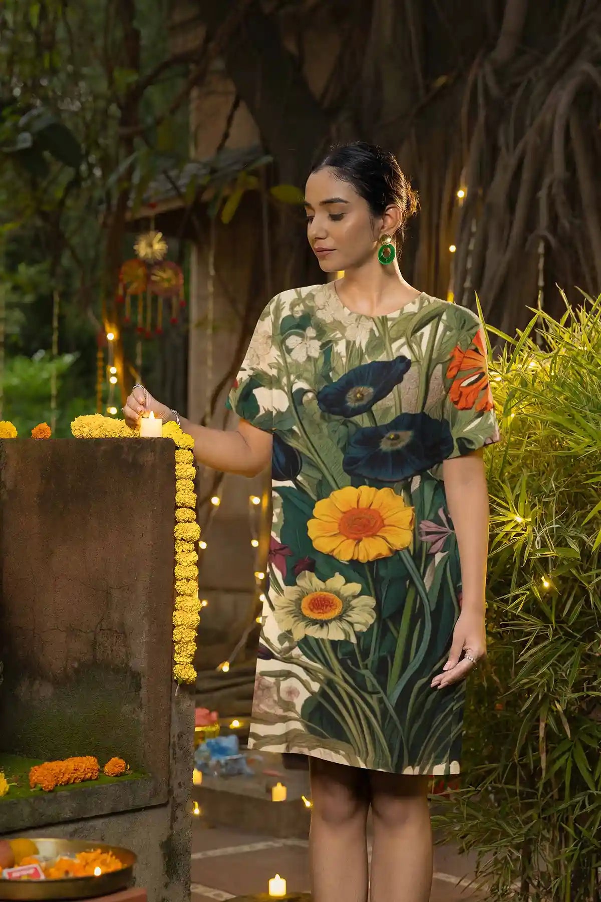 Botany Continuum digital art print on T-shirt dress worn by a woman lighting a candle for Diwali.