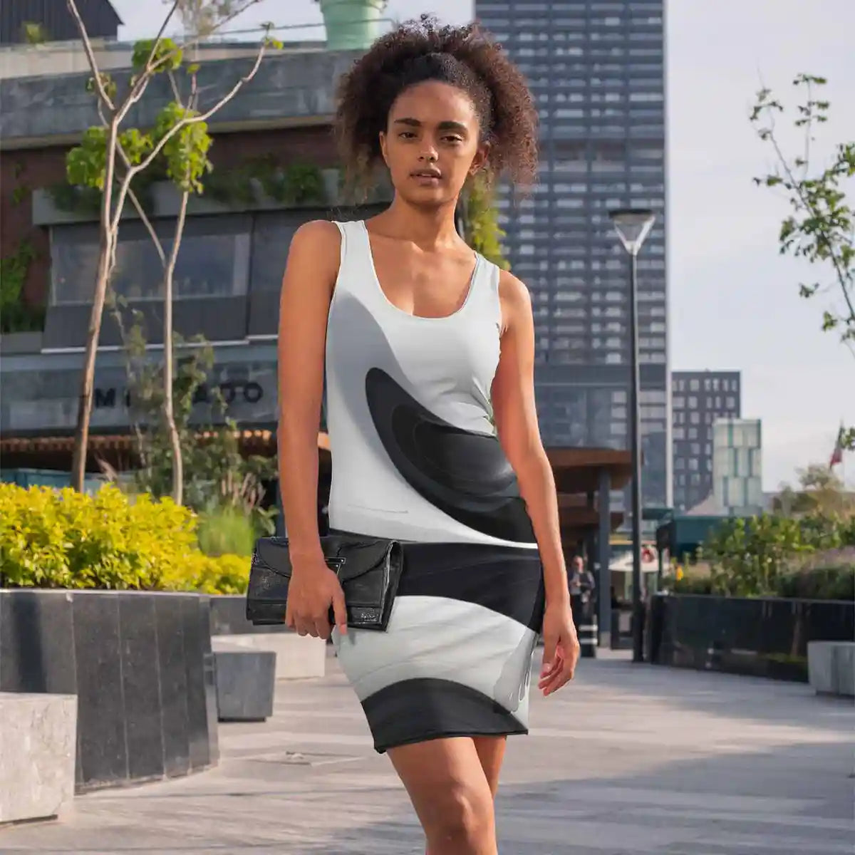BW Ebb art print on racerback dress featuring a trendy woman walking in the city.