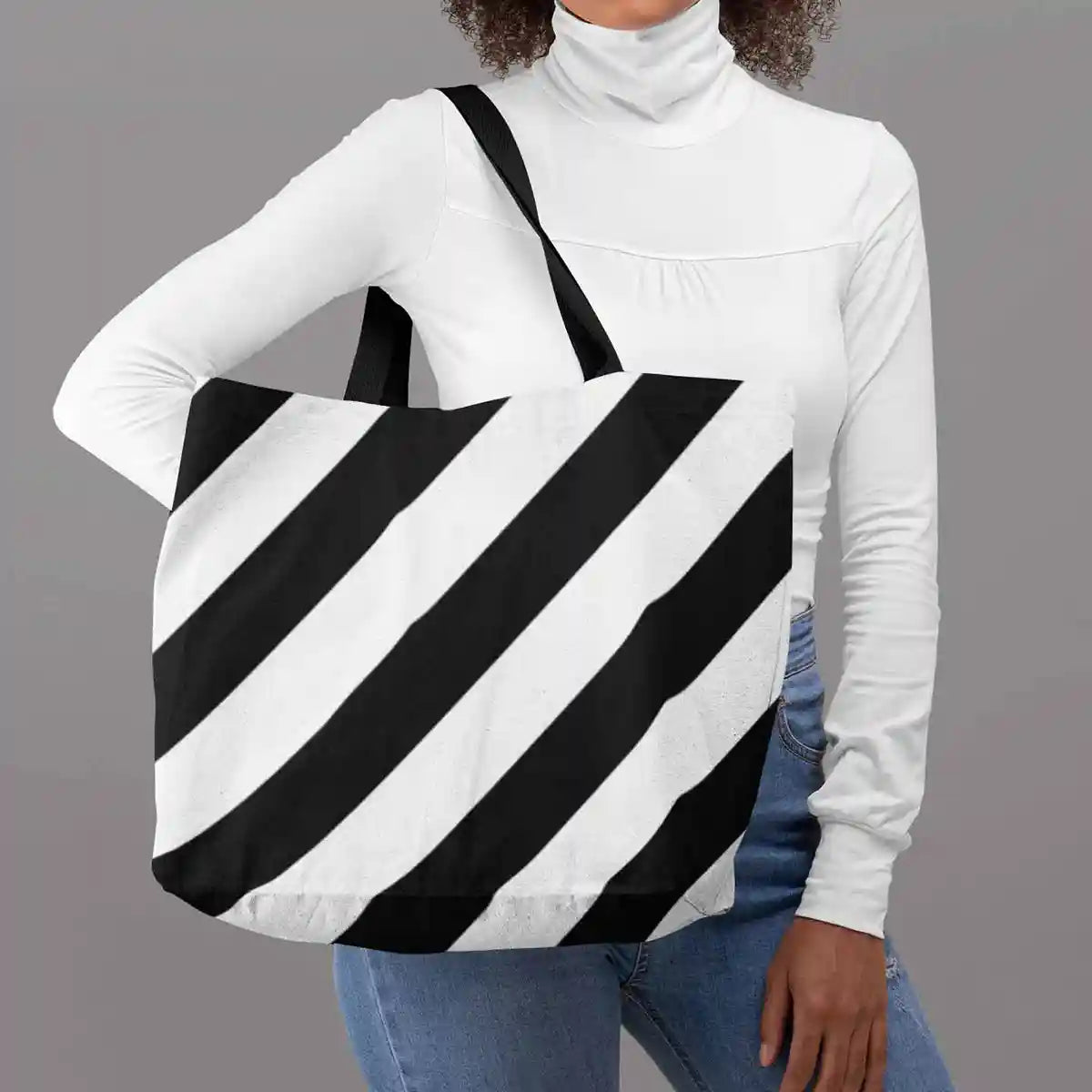 Tote bag featuring Diagonal Stripes digital art print, woman posing in studio.