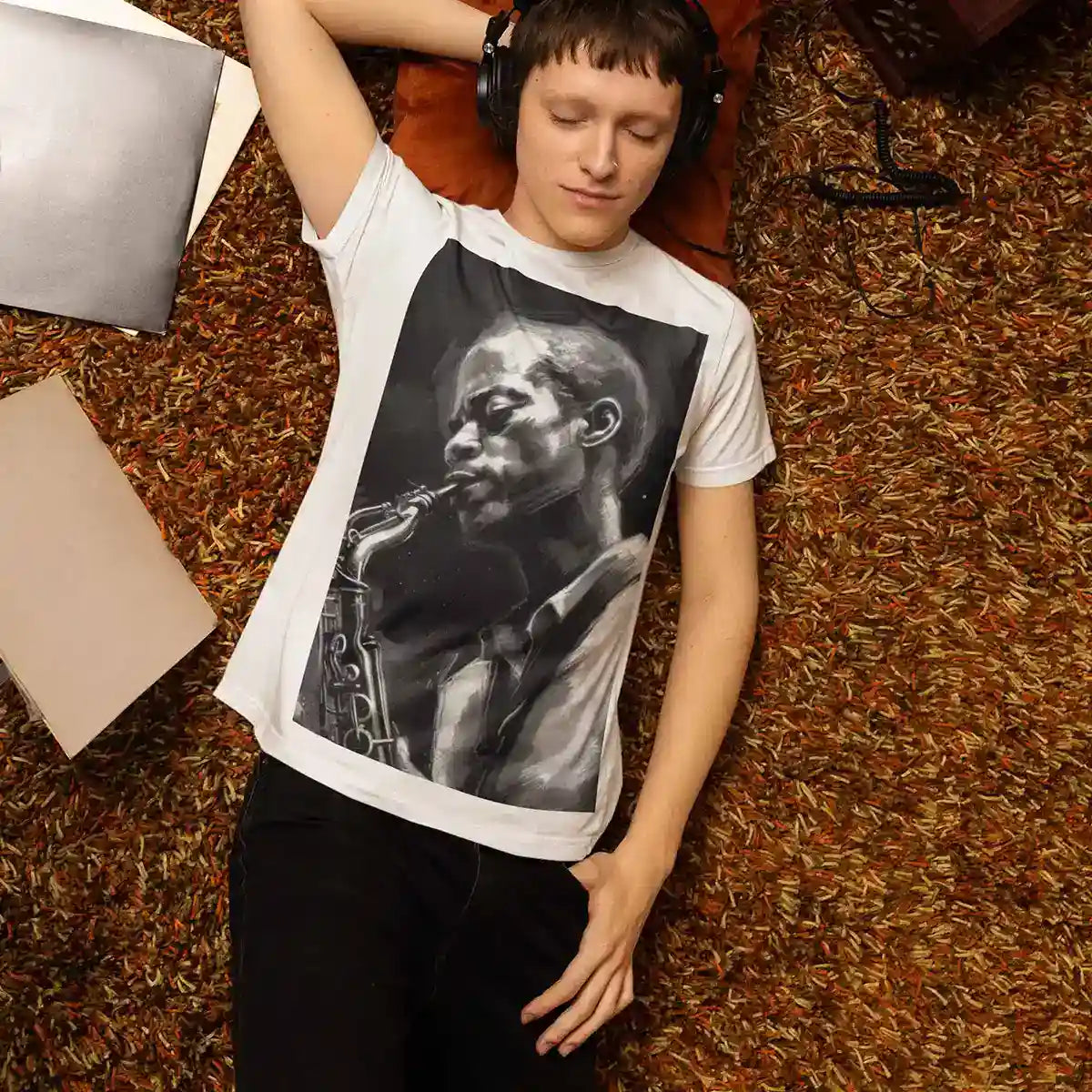Man listening to music surrounded by vinyl records wearing Jazz Musician art print tee.