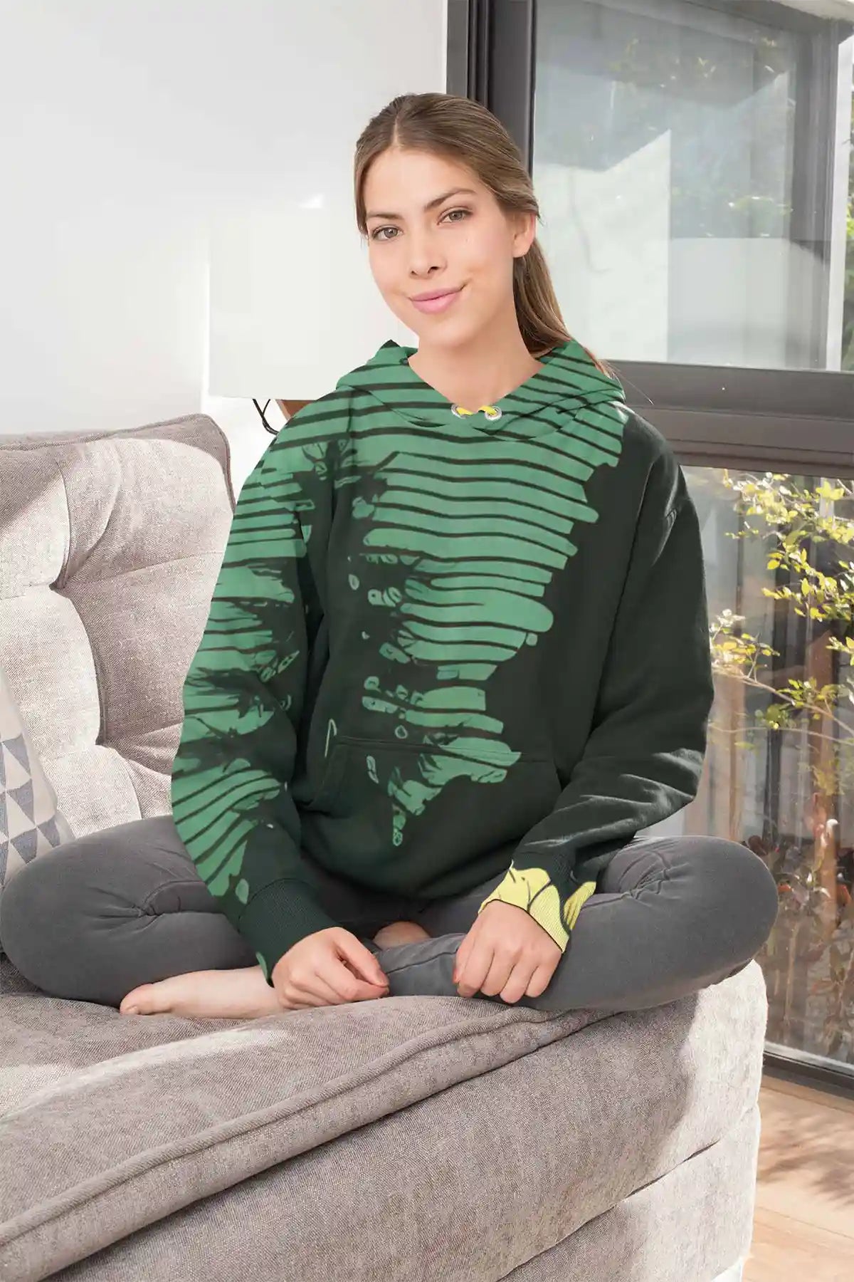 Lakeside Gem digital art print on a sublimated pullover hoodie featuring a young woman sitting on a fabric couch.