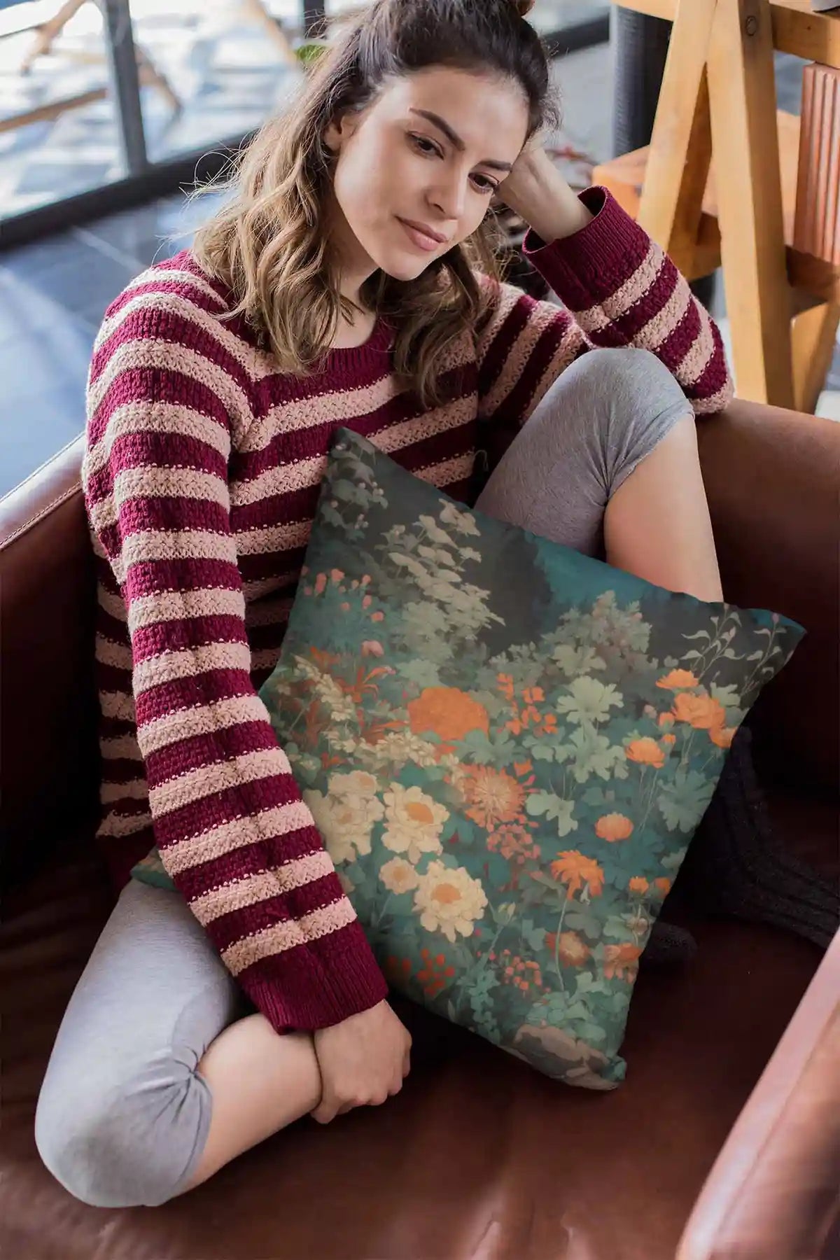 Midnight Garden digital art print on a pillow featuring a girl sitting on a leather sofa, depicting a serene garden with vibrant flowers under moonlight.