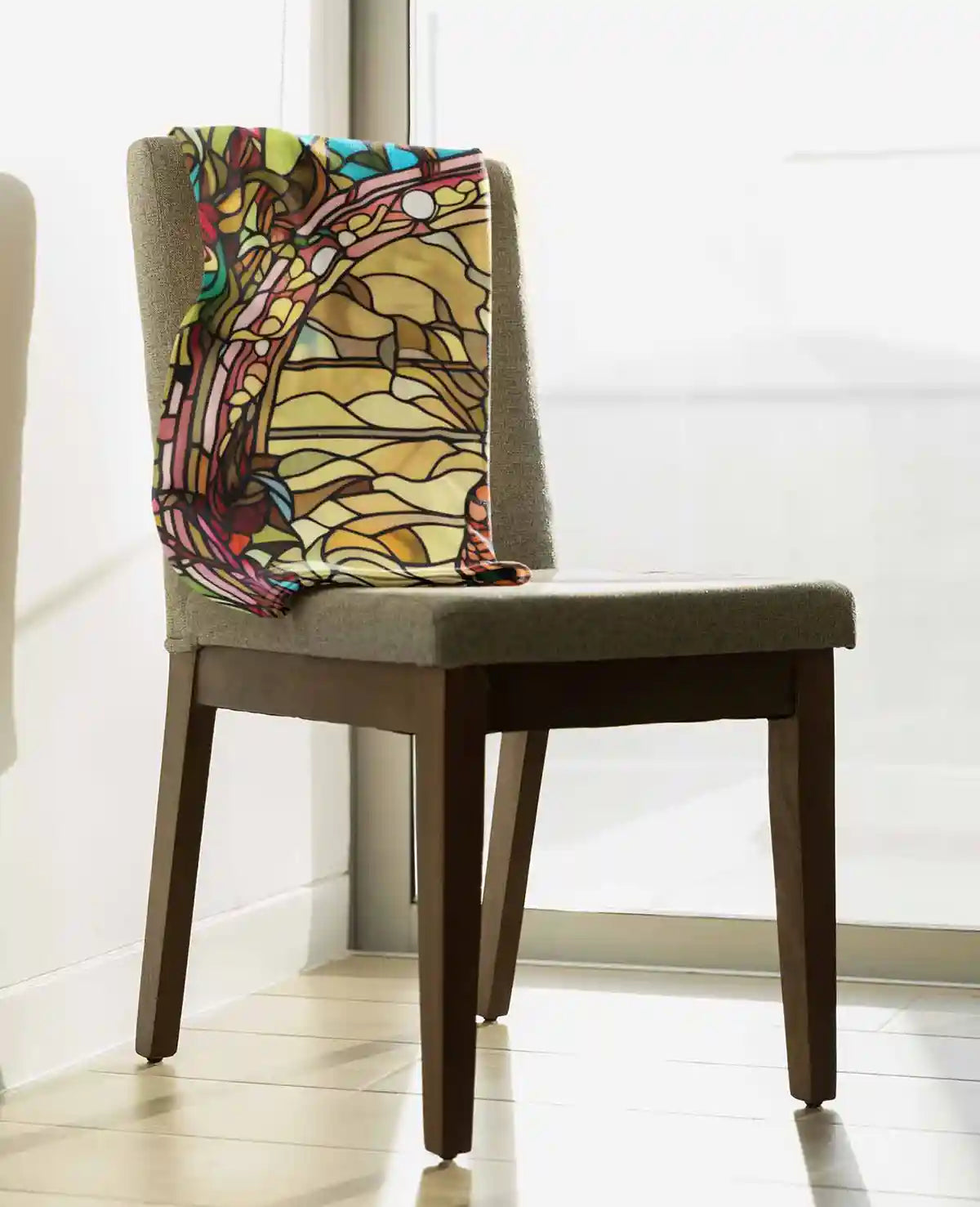 Peacock 1 digital art print on a sublimated throw blanket placed over a chair, showcasing a vibrant stained glass peacock design.