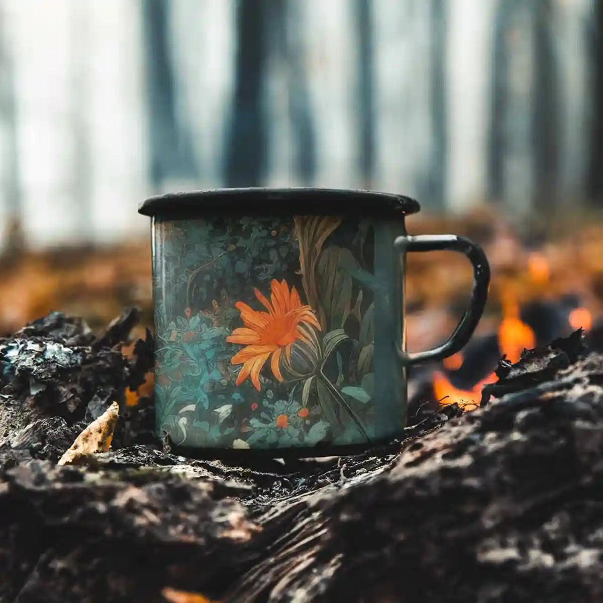 Silent Grove digital art print on a 12 oz enamel mug placed by a bonfire, showcasing a serene forest scene with vibrant flowers, blending contemporary art with natural beauty.