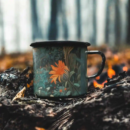 Silent Grove digital art print on a 12 oz enamel mug placed by a bonfire, showcasing a serene forest scene with vibrant flowers, blending contemporary art with natural beauty.