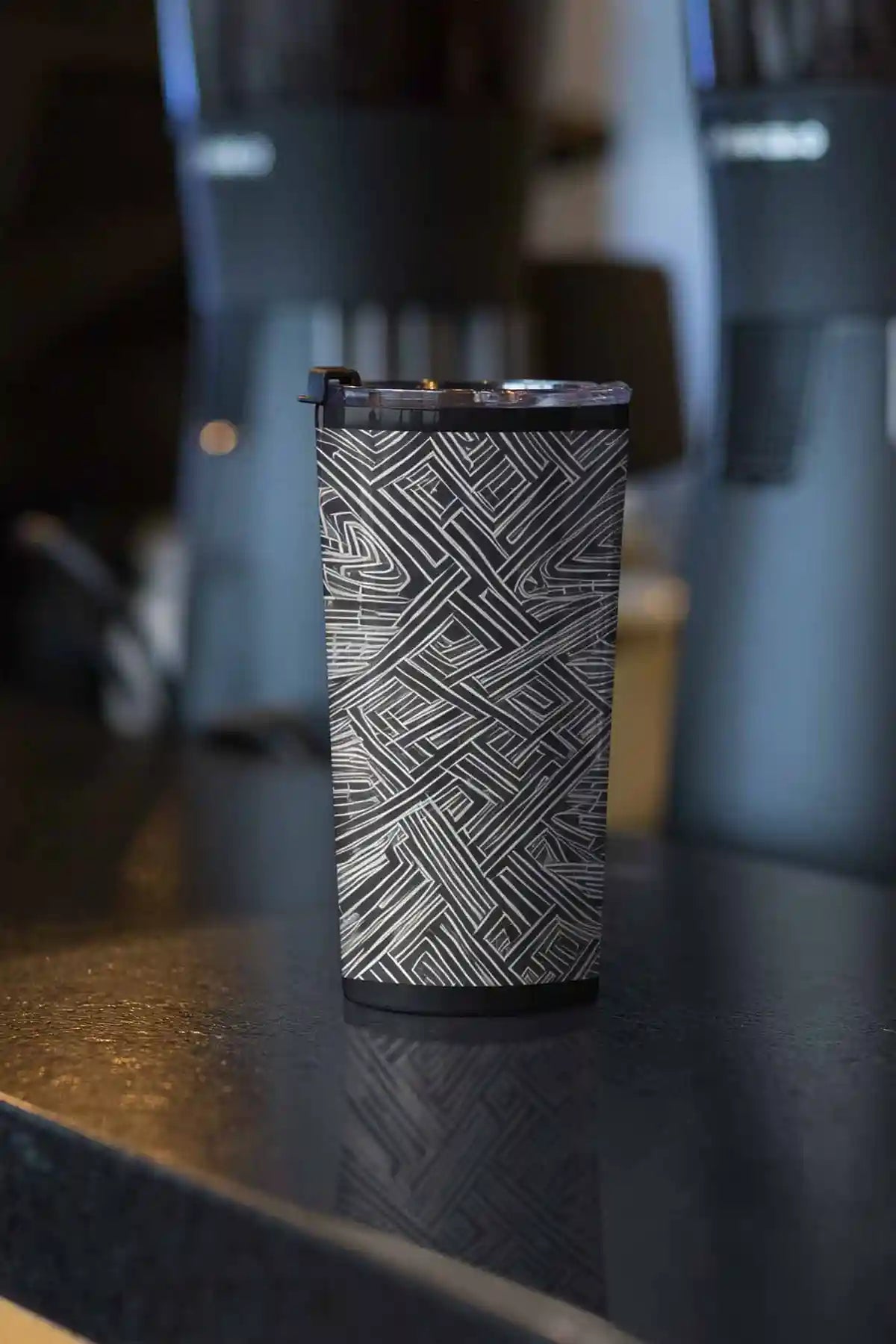 Soulprint digital art print on a travel mug placed on a kitchen bar, featuring intricate geometric patterns and a modern, contemporary art design, seamlessly blending into the kitchen space.