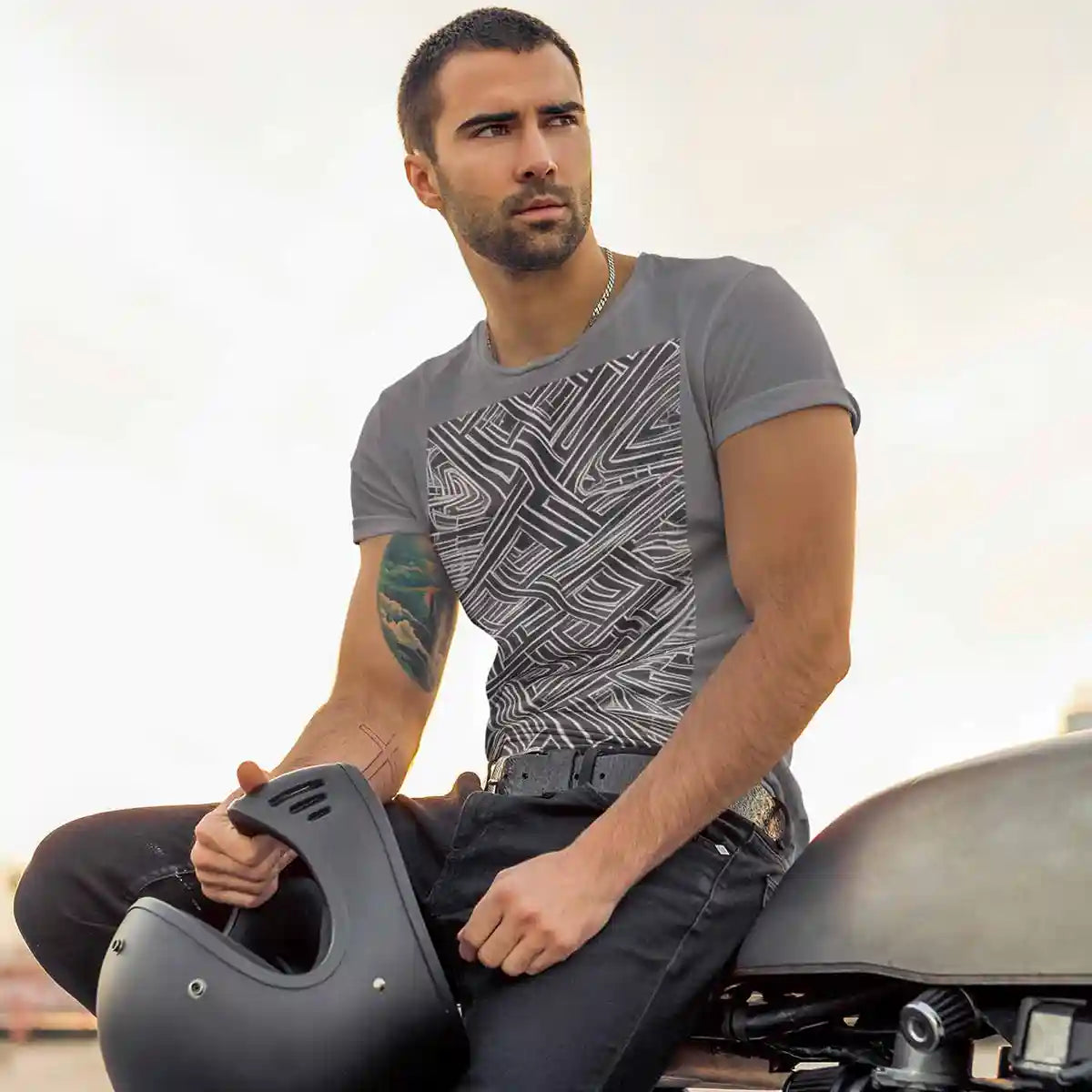 Tattooed stylish man posing on bike wearing tee with Soulprint digital art print.