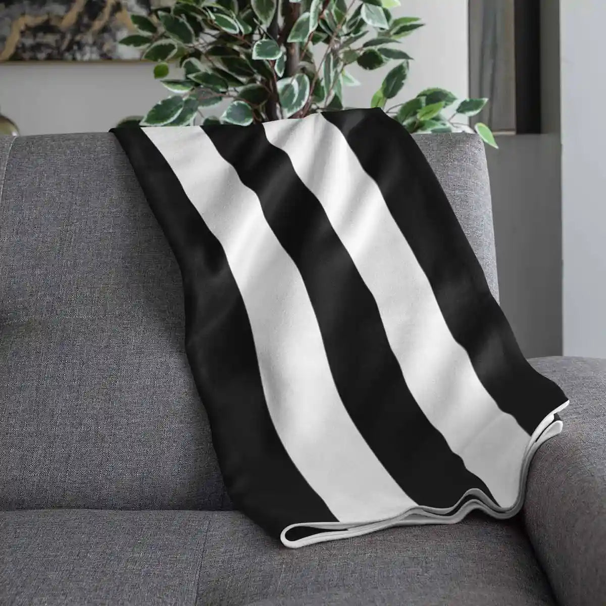 Throw blanket with Vertical Stripes digital art print draped over couch.